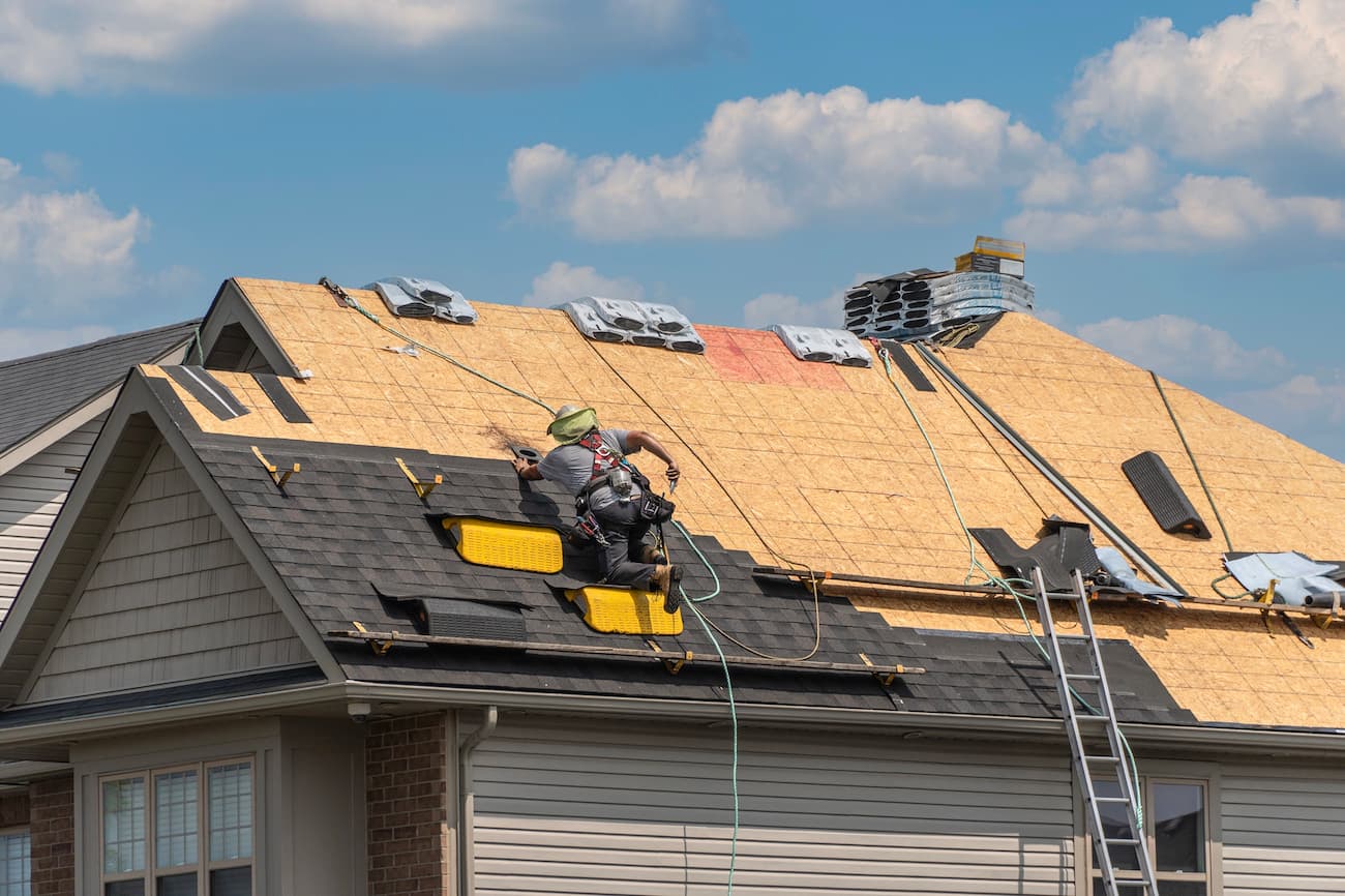 Roofers replacing the roof of a home